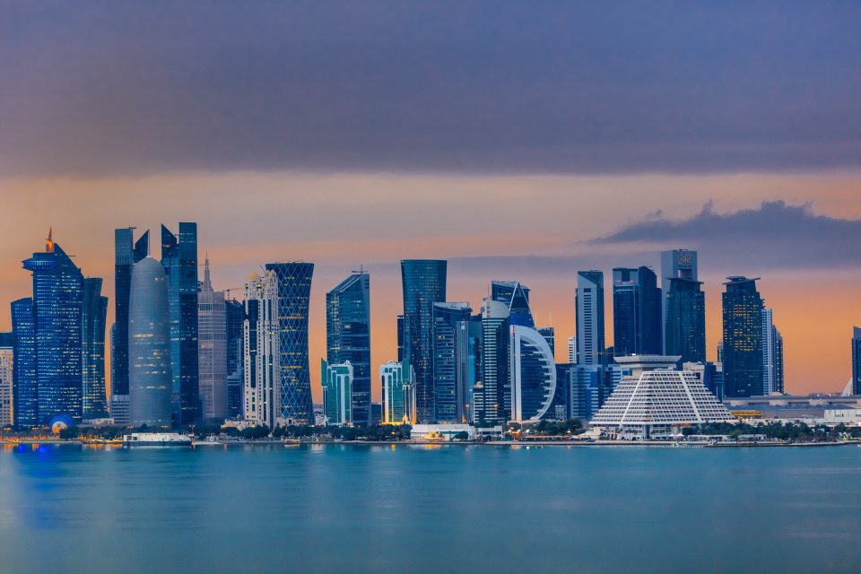 Doha's West Bay skyline at dusk, seen across the water